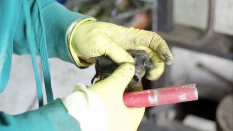 Mechanic figuring out problem with ball bearing cross joint Stock Footage 128921558