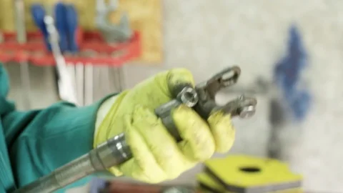 Mechanic figuring out problem with ball bearing cross joint Stock Footage 128921589