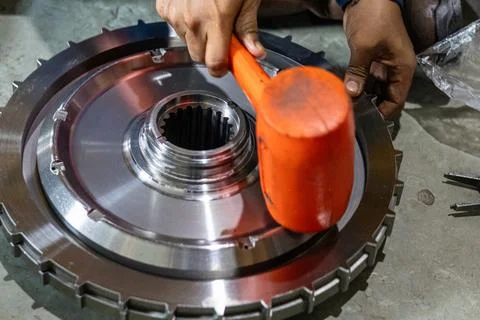 Mechanic Fitting Heavy Gear Component Using Rubber Dead Blow Mallet. Stock Photos
