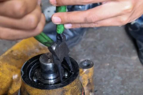 Mechanic Fitting Snap Ring on Bearing Housing with Pliers. Stock Photos