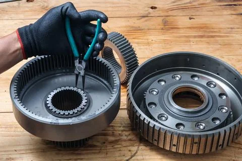Mechanic Fitting Snap Ring on Ring Gear Drum with Pliers. Stock Photos