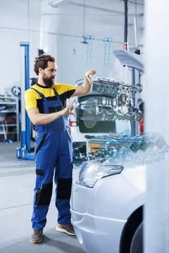 Mechanic fixes car engine with AR tech Stock Photos