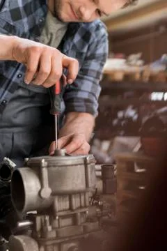 Mechanic fixing car engine at auto repair shop Stock Photos