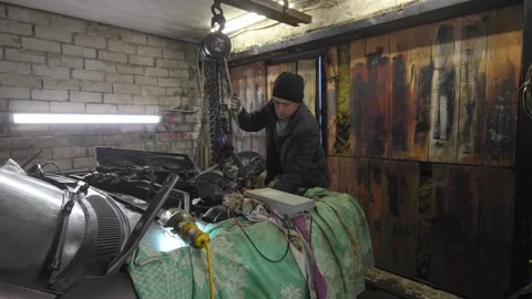 Mechanic fixing car engine in garage Stock Footage 304119093