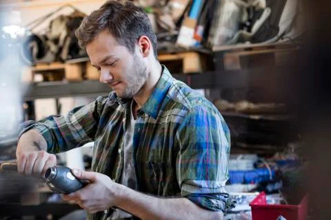 Mechanic fixing car part in auto repair shop Stock Photos