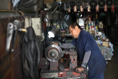 Mechanic fixing disc brake by machine Stock Photos
