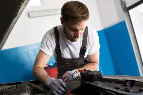 Mechanic fixing electronics accumulator Stock Photos