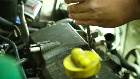Mechanic fixing engine with screwdriver Stock Footage 310521226