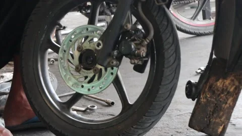 Mechanic fixing motorcycle tires. Stock Footage 239506789