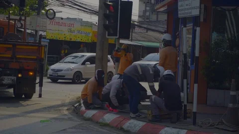 Mechanic is fixing the road Near the traffic signal : Chiang Mai / Thailand Stock Footage 123748013