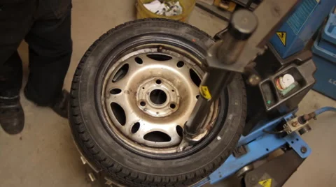 Mechanic fixing a tyre Stock Footage 63547087