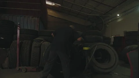 Mechanic in a garage grabs tool and gets to work Stock Footage 275075457