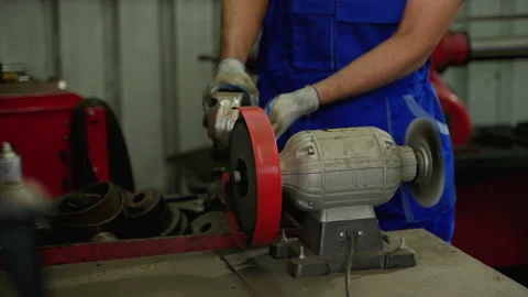 The mechanic is grinding the brake discs in the workshop. Stock Footage 204924252