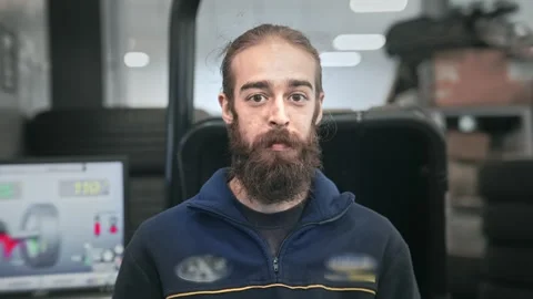 Mechanic guy close up portrait. Technician man look at camera. Car tire service. Stock Footage 271222799