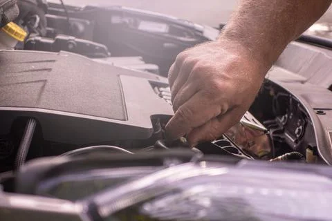 Mechanic hand checking the engine of a car. 스톡 사진