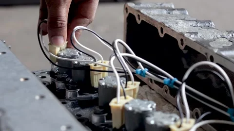 Mechanic Hand Connecting Wire Harness Terminal Onto Solenoid Valve Body. Stock Footage 344688406