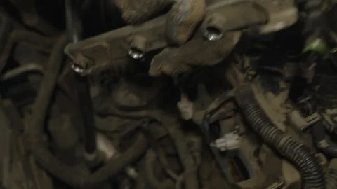 Mechanic hand in glove installing fuel rail with injectors into a car engine Stock Footage 340559079