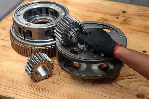 Mechanic Hand Inserting Needle Bearing and Spur Pinion into Planetary Gear .. Stock Photos