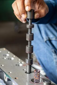 Mechanic Hand Inserting Spool Valve Shaft Into Hydraulic Valve Block. Stock Photos