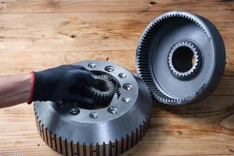 Mechanic Hand Installing Sun Gear into Planetary Carrier. Stock Photos