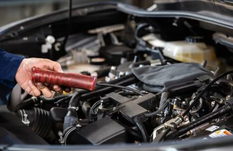 Mechanic hand using Tachometer checking engine of car 写真素材