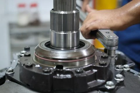 Mechanic hand using torque wrench tighten bolts Stock Photos