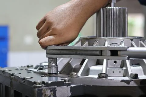 Mechanic hand using torque wrench tighten bolts Stock Photos