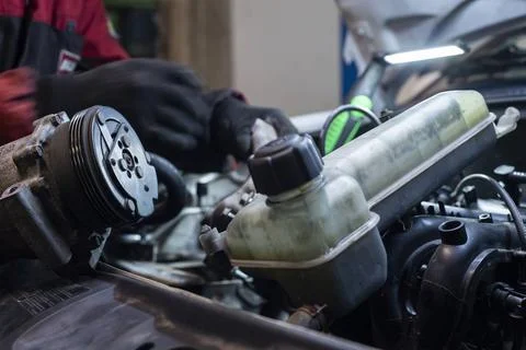  Mechanic hand at work on the engine in the workshop Mechanic hand at work... 写真素材