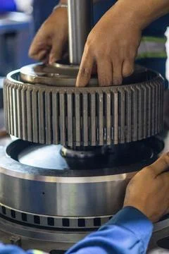 Mechanic Hands Assembling Heavy Transmission Steel Spur Gear Component. Stock Photos