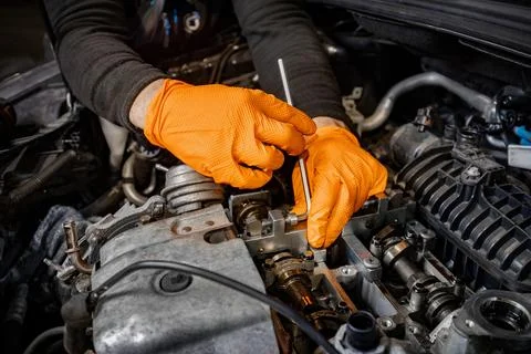 Mechanic Hands Fixing Car Engine in Service Stock Photos