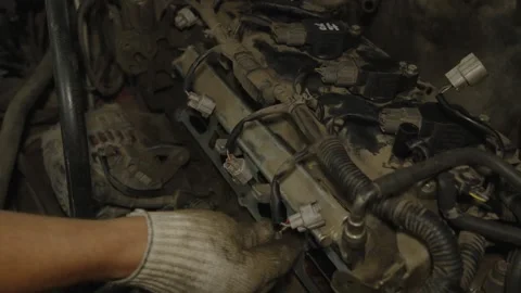 Mechanic hands in gloves inspecting and repairing a dusty car engine block Stock Footage 340559318