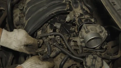 Mechanic hands in gloves inspecting and repairing a dusty car engine intake Stock Footage 340559335
