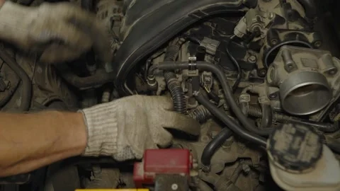 Mechanic hands in gloves inspecting and repairing a dusty car engine intake Stock Footage 340559364