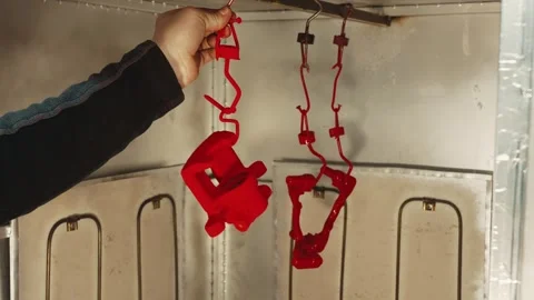 Mechanic hangs freshly painted auto parts in oven to dry in professional car Stock Footage 285642155