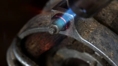 Mechanic heating up the stucked rusty nut bolt Stock Footage 307017719