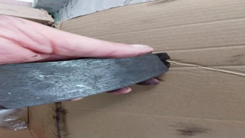 Mechanic holding an old rusty car brake pad in dirty hand Stock Footage 336004937