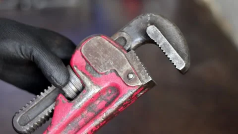 Mechanic Holding Red Pipe Wrench Tool. Stock Footage 342080346