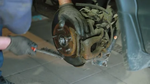 Mechanic Inspecting Brake Disc During Tire Replacement Service Stock Footage 337829573