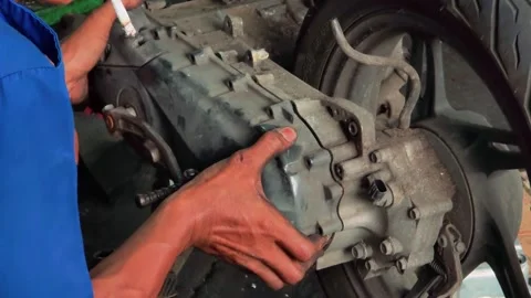 Mechanic inspecting motorcycle engine repair process with technical focus Stock Footage 332126239