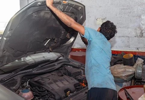 Mechanic Inspecting Rusted Car Engine Stock Photos