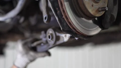 Mechanic Inspecting Rusty Brake Disc and Caliper on Car Wheel Hub Stock Footage 345570856