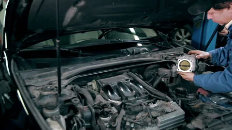 Mechanic inspecting the throttle body Stock Footage 58097766