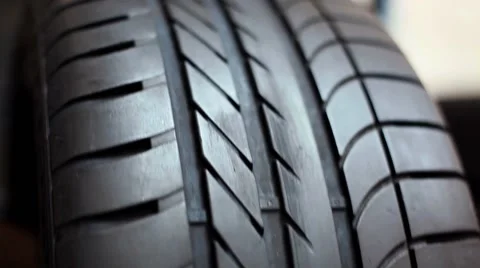 Mechanic inspecting tire on balancing machine Stock Footage 49957670