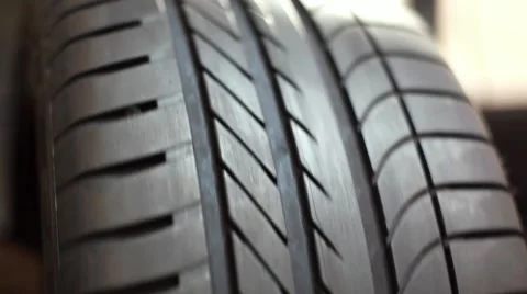 Mechanic inspecting tire on balancing machine Stock Footage 49957693