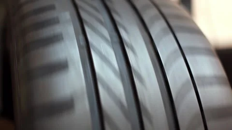 Mechanic inspecting tire on balancing machine Stock Footage 49957698