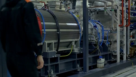 A mechanic inspects a compressor unit at work. Stock Footage 104225560