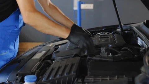 Mechanic Inspects Engine and Notes Repairs Under Car Hood Stock Footage 315145076