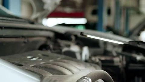 Mechanic inspects engine with a flashlight Stock Footage 158507408