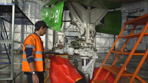 A mechanic inspects front strut passenger aircraft. 4K Stock Footage 95644915
