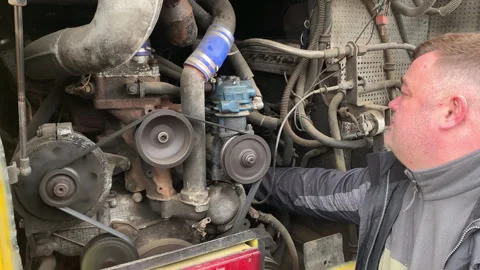 A mechanic inspects a running bus engine. Stock Footage 304176436